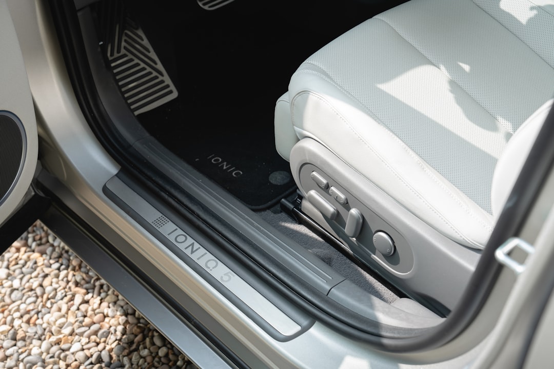 Interior view of a modern car's driver seat and door.